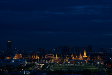 Fototapeta na wymiar Glowing gold light of Buddhist temple at twilight time, Bangkok, Thailand