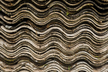 Stack of old asbestos slate roof sheets, wave pattern