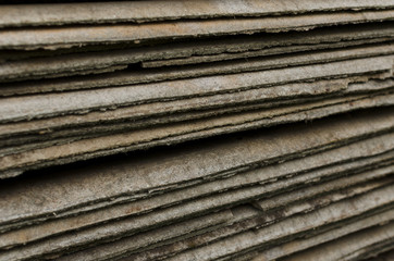 Stack of old asbestos slate roof sheets pattern closeup