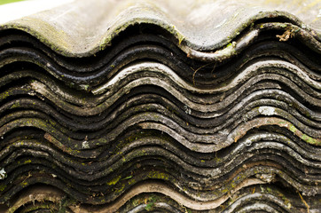Stack of old asbestos slate roof sheets, wave pattern