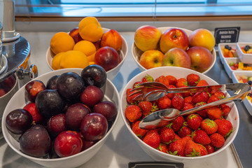 Assortment of colorful fresh fruits at breakfast buffet in hotel