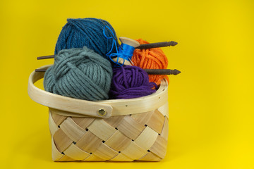 Knitting yarn balls and needles in basket