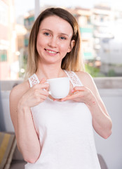 Young woman is posing with tea