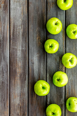 Green apples pattern on dark wooden background top view frame copy space
