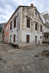 Fototapeta na wymiar Old house with brown shutters in the mediterrenean city
