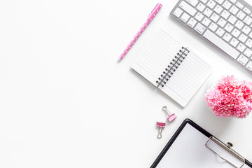 Female work desk with pink supplies on white background flat lay copy space top view top view