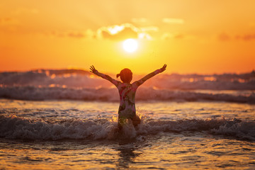 silhouette at sunset.girl in the sunset.silhouette jump. Silhouette life and activity on the beach...