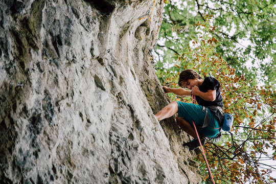 Free climber climbing a natural rock
