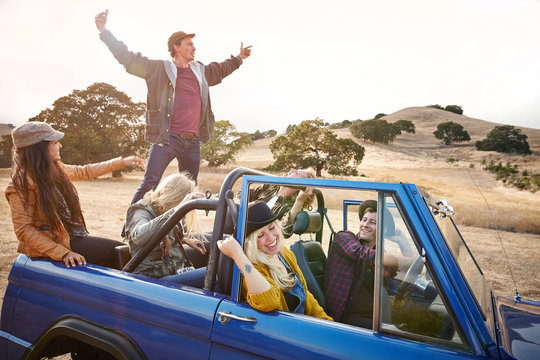 Group of friends on a road trip in nature having fun
