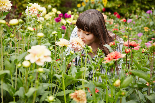 Woman smelling flowers in a garden on a farm