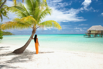 Woman standing on beach looking at view