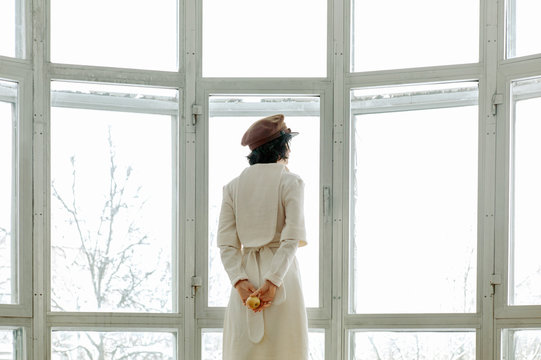 Elegant woman against white window