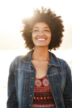 Portrait of mixed race woman smiling on the beach
