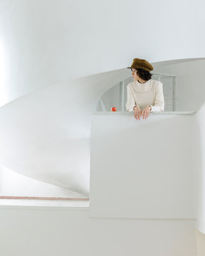 Woman with apple in white modern interior