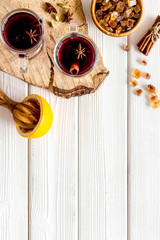 Mulled wine and fir branches frame on white wooden background top view space for text