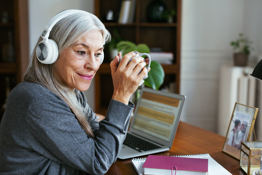 Senior woman working at home office.