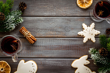 Background with mulled wine and New Year decoration on dark wooden background top view frame copy space