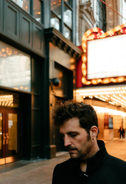 portrait of a man leaving a theater in the city of chicago