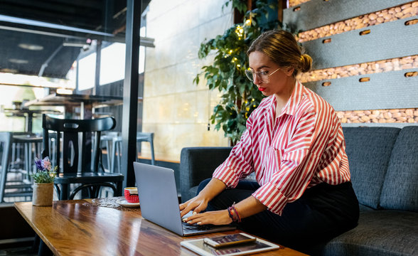 Woman in a cafe - Powered by Adobe
