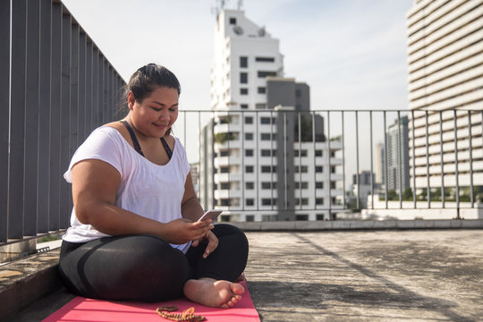 Beautiful woman practicing yoga on the rooftop
