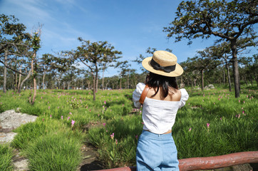 girl shooting nature photo in forest 