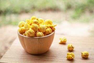 baked popcorn for eating in wooden bowl 