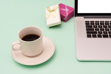 Fototapeta na wymiar Coffee, laptop and gift box on the table