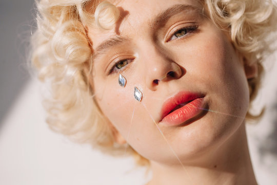 Sparkling artificial tears on blonde woman