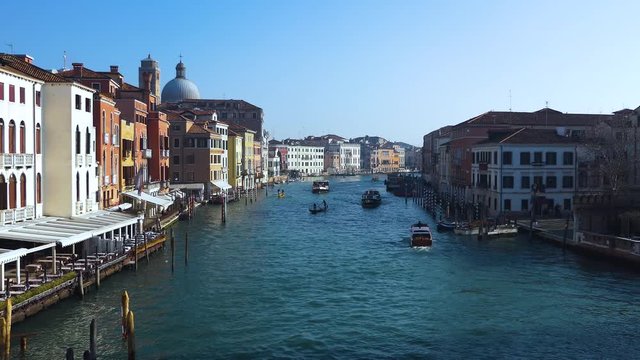 Venice city canal with gondolas, boats, buildings. Royalty free UHD 4K stock footage related to European and Italian history, culture, tourism.