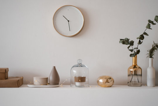 Composed glass vases with garland on shelf