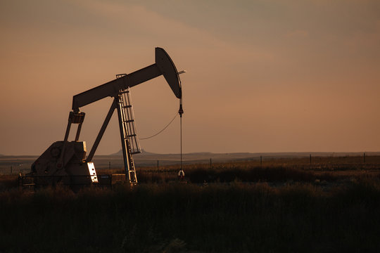 Oil derrick at dusk in North Dakota bakken.