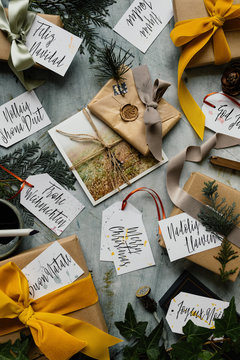 Wrapping gifts for Christmas with ribbons, wax stamps and photographs