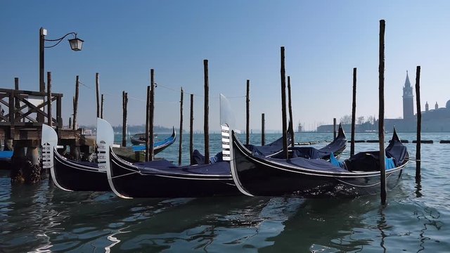 Venetian gondolas prepared for the canal trip. Royalty free UHD 4K stock footage related to European and Italian history, culture, and tourism.
