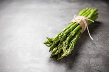 Fresh green asparagus on table.