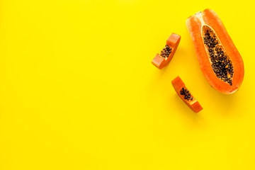 Exotic fruit. Papaya slises on yellow background top view space for text