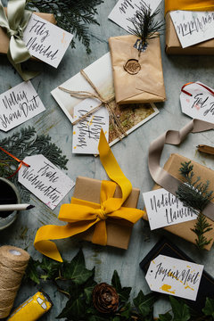 Overhead shot of christmas gifts and tags with message in many different languages