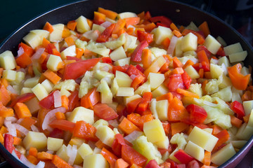 Steamed vegetables on frying pan 