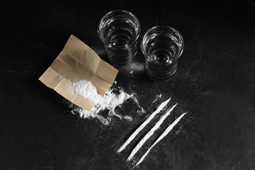 close up pile of cocaine in paper and vodka on black background, cocain on black background