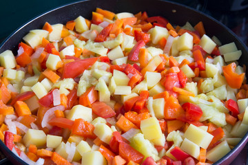 Steamed vegetables on frying pan 