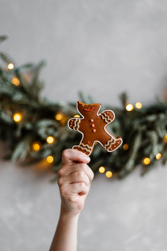 Crop hand with bitter gingerbread man