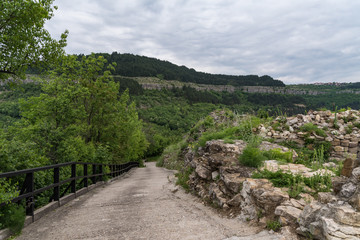 Fototapeta na wymiar Road to hill of Trapezitsa fortress with Veliko Tarnovo old city at background in Bulgaria.
