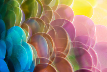 Mermaid scale paillettes photographed through a prism