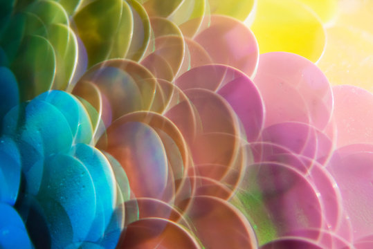 Mermaid scale paillettes photographed through a prism