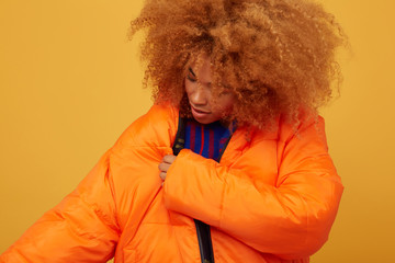 Young woman studio portrait fitting jacket