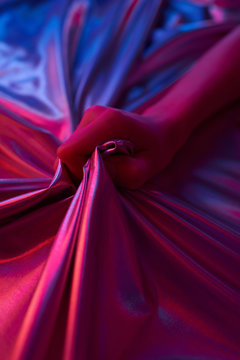 Sensual Female Hand Grabbing Holographic Sheet