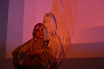 Model in overlay digital neon lights