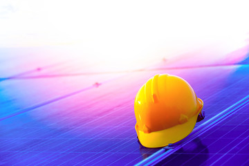 Yellow helmet with photovoltaic in the solar power plant,maintenance panels collect solar energy,concept of sustainable resources,copy space