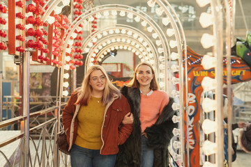 Two Girls Having Fun At The Amusement Park