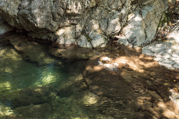 a water reservoir in the rocky creek with crystal clear water