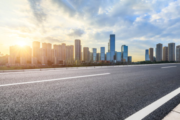 Empty asphalt road and Chongqing cityscape at sunset